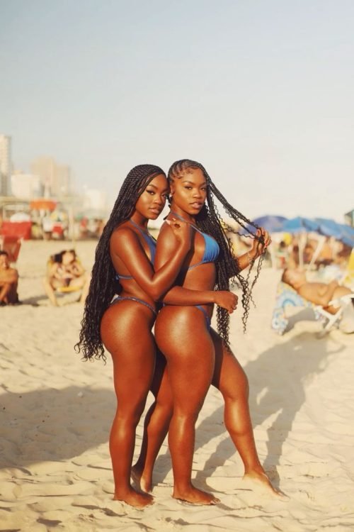 Girls on girls chat UK featuring two confident women Lesbian phone chat UK duo with braided hairstyles Women seeking women chat profile at the beach Girls on girls phone chat profile image Lesbian chat lines UK female duo
