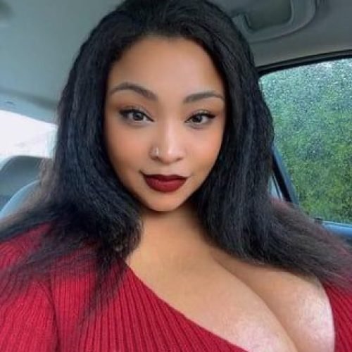 Confident curvy woman in a car selfie representing phone sex chat UK and adult chat with horny girls