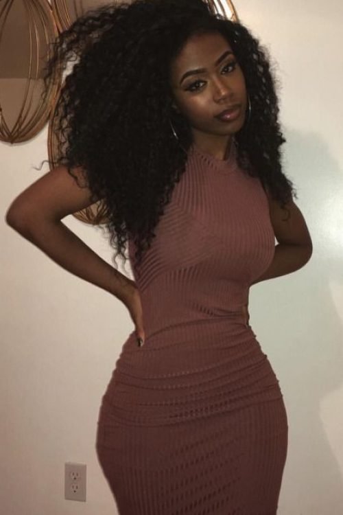 Confident woman in fitted dress representing phone sex chat UK and adult chat