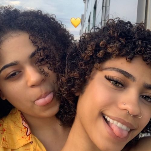 Girls on girls chat UK profile featuring two women with natural curls Lesbian phone chat UK friendly female duo Women seeking women chat profile with casual style Girls on girls phone chat UK profile image Lesbian chat lines UK confident female pair