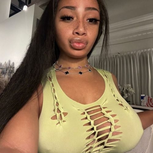 Flirty UK phone chat model Alinaya Rose with freckles, long dark hair, and playful confident energy