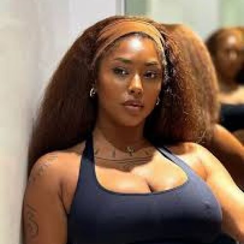 Confident woman in sporty outfit representing adult chat UK and phone sex chat